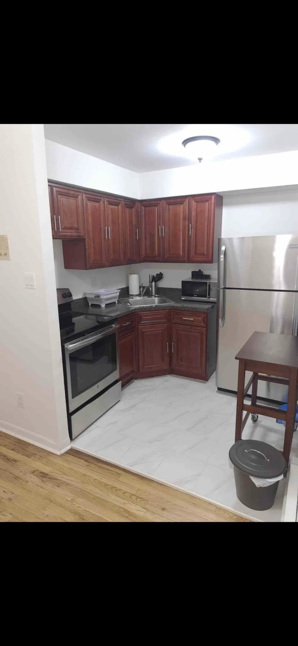 Modern kitchen with stainless steel appliances.