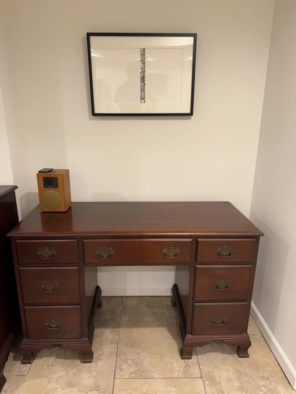 Wooden desk with framed art.