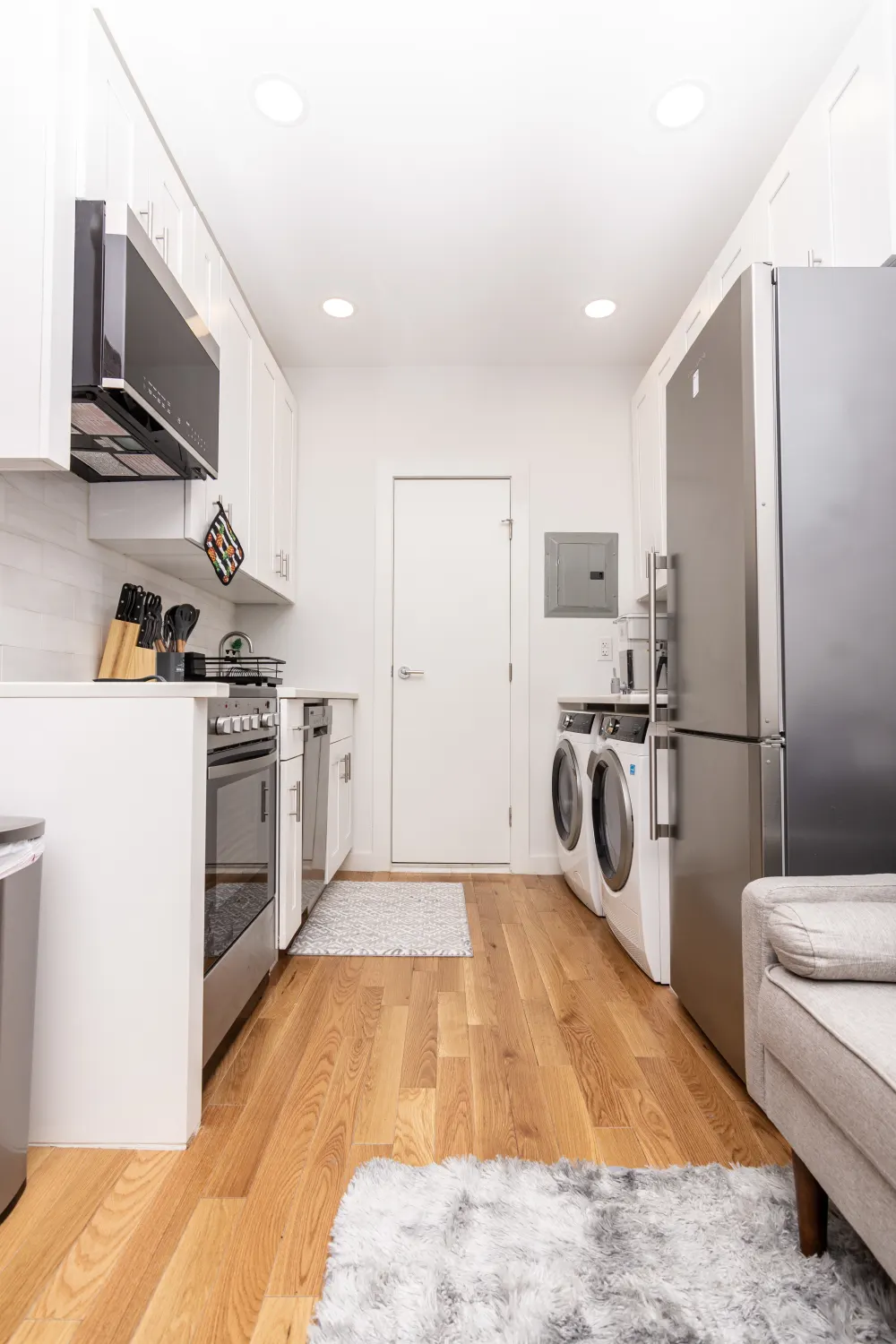 Compact modern kitchen with laundry appliances.