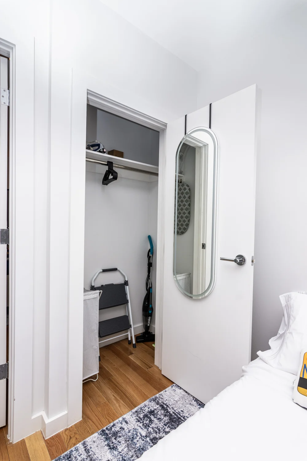 Small closet with cleaning supplies.