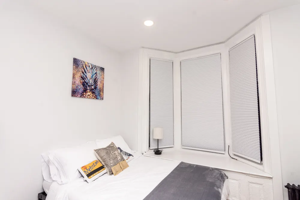 Bright cozy bedroom with artwork.