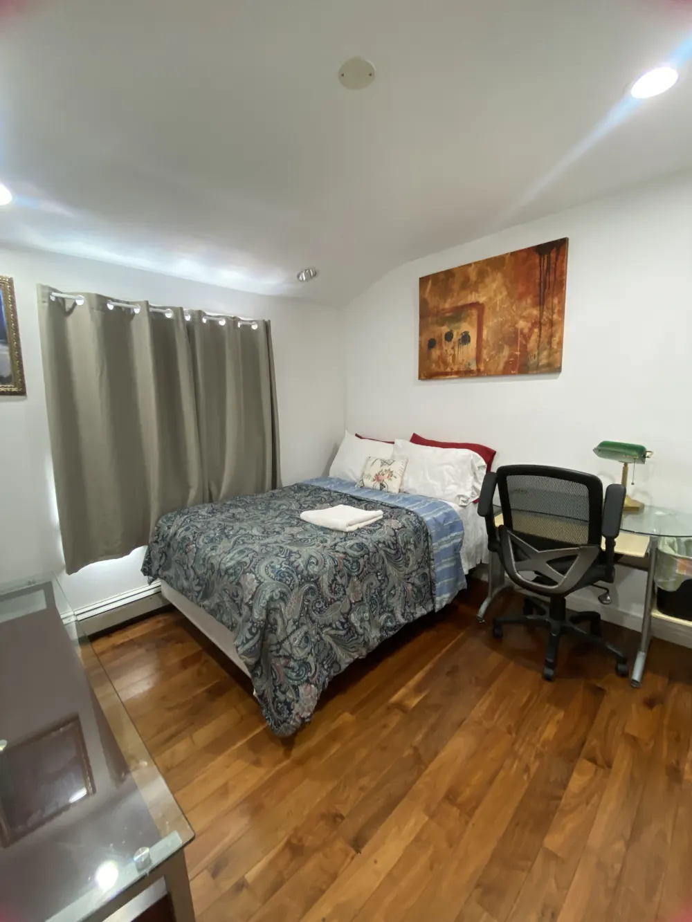 Cozy bedroom with wooden floor.