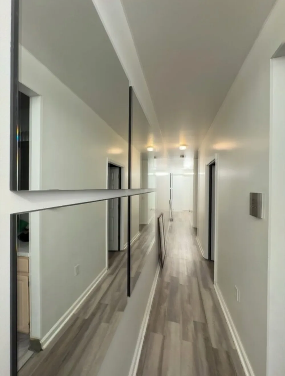 Narrow hallway with large mirrors