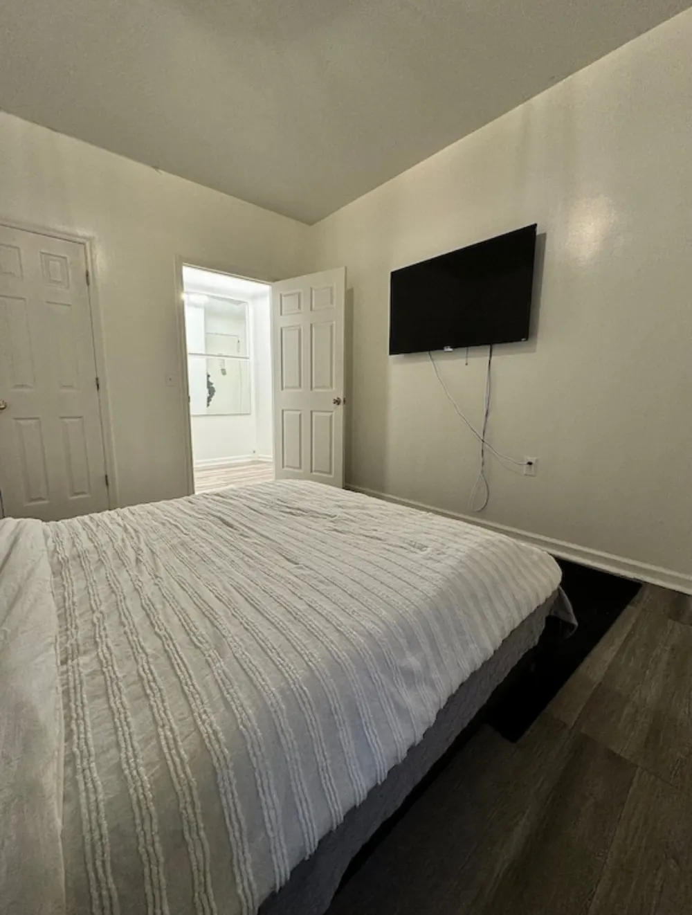 Modern bedroom with wall-mounted TV