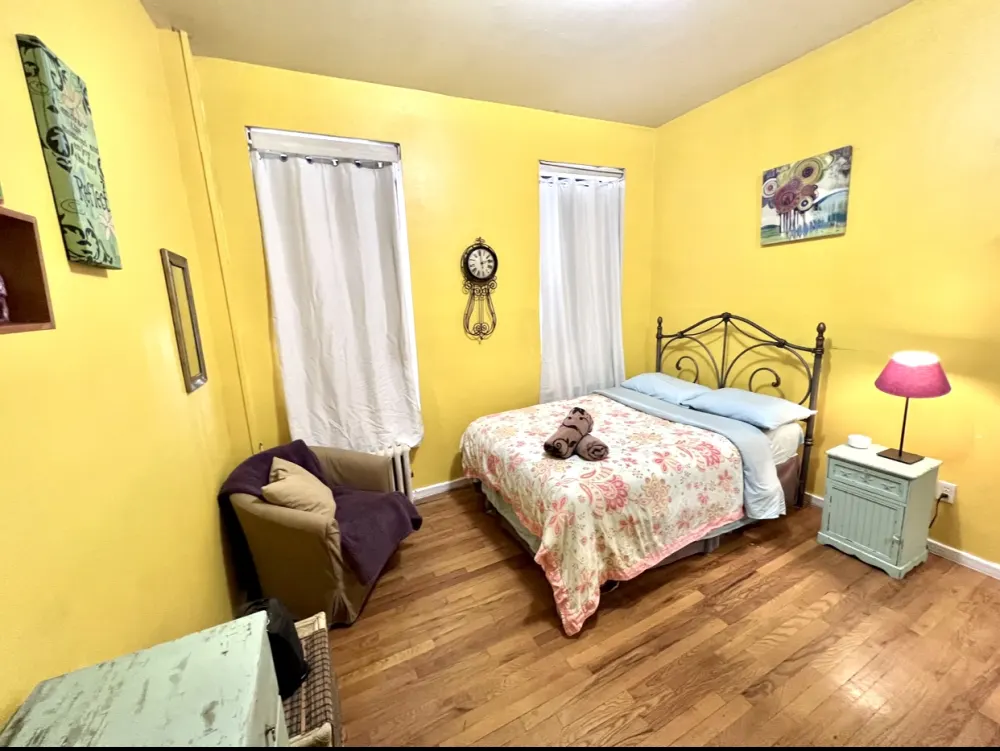 Cozy bedroom with yellow walls.