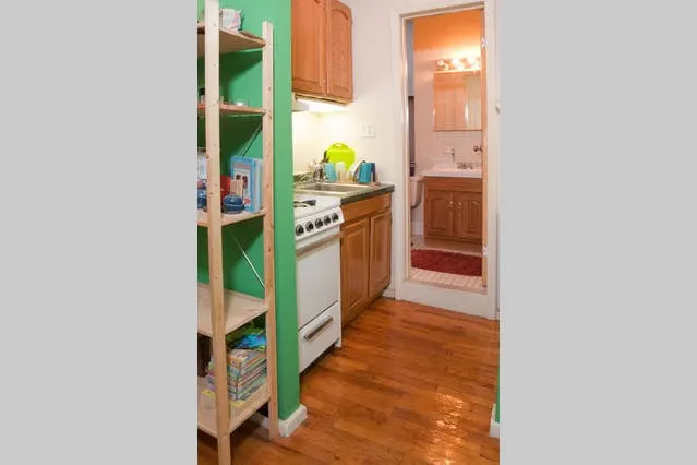 Cozy kitchen with bathroom adjacent.