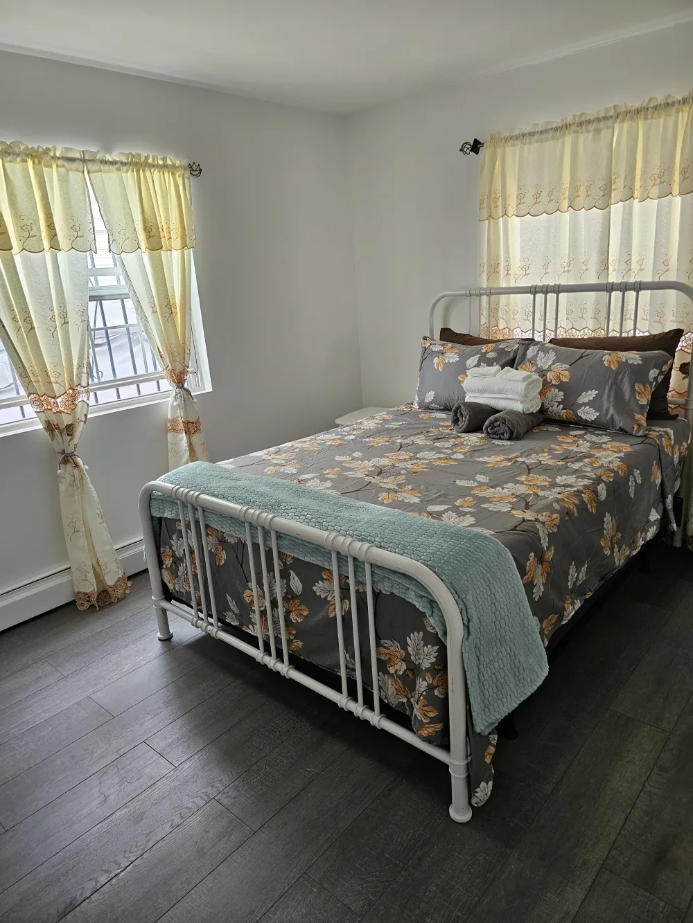 Cozy bedroom with floral bedding.