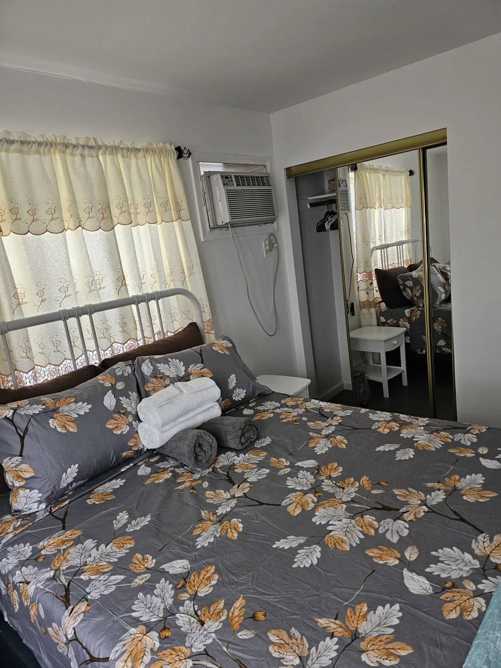 Cozy bedroom with floral bedding.