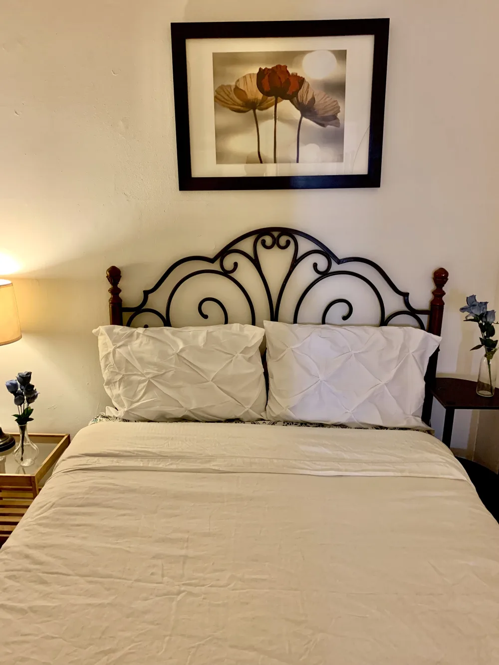 Ornate bedframe and floral artwork.