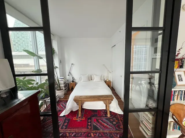 Modern bedroom with large windows.