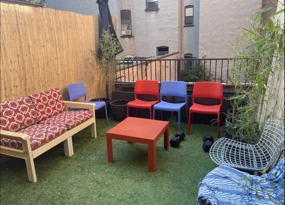 Cozy patio with colorful chairs.