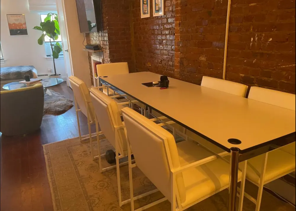 Cozy dining area with brick walls.