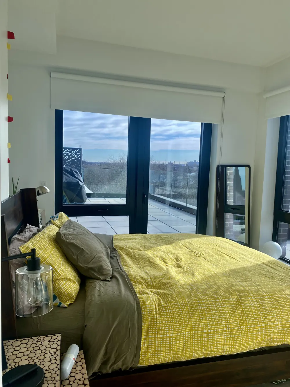Bright bedroom with balcony view.