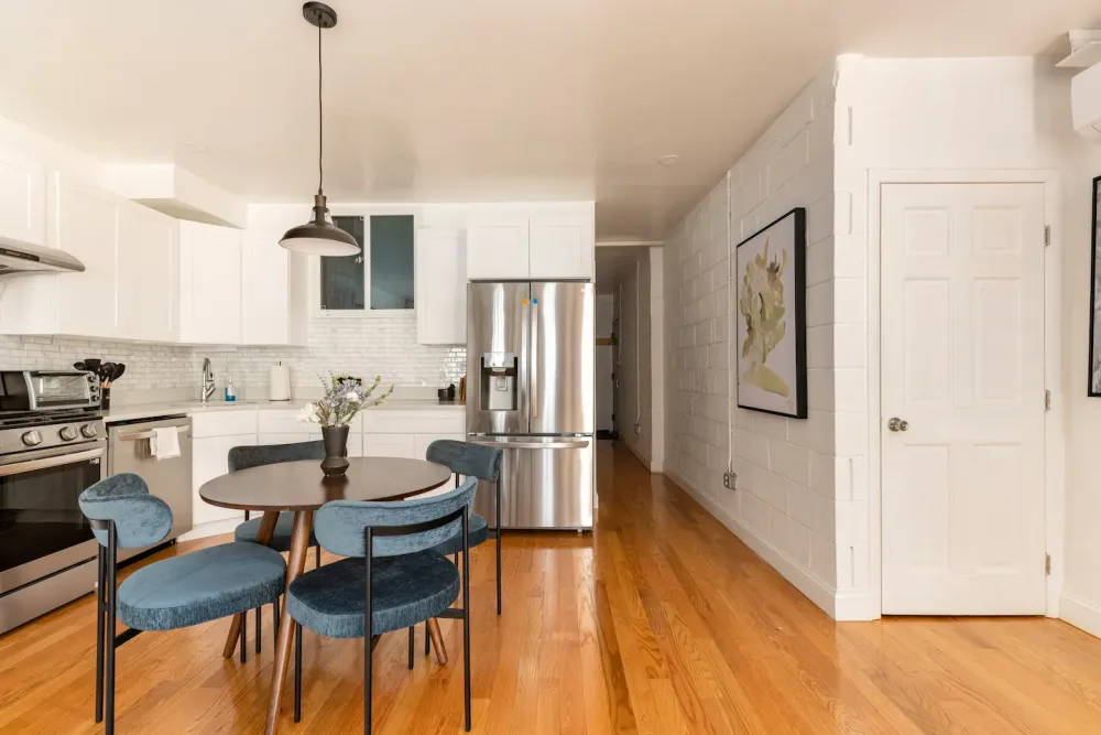 Modern kitchen with blue chairs.