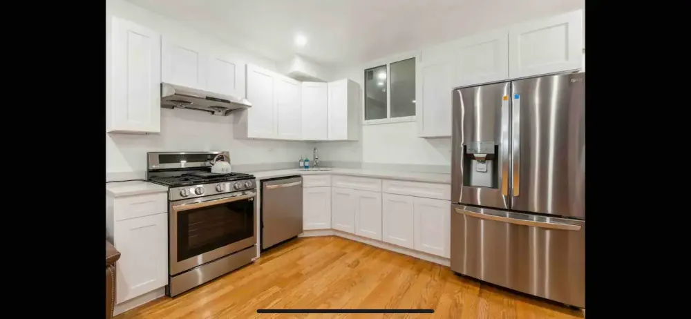 Modern kitchen with stainless appliances.