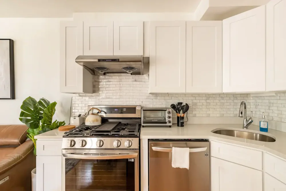 Modern kitchen with stainless appliances.