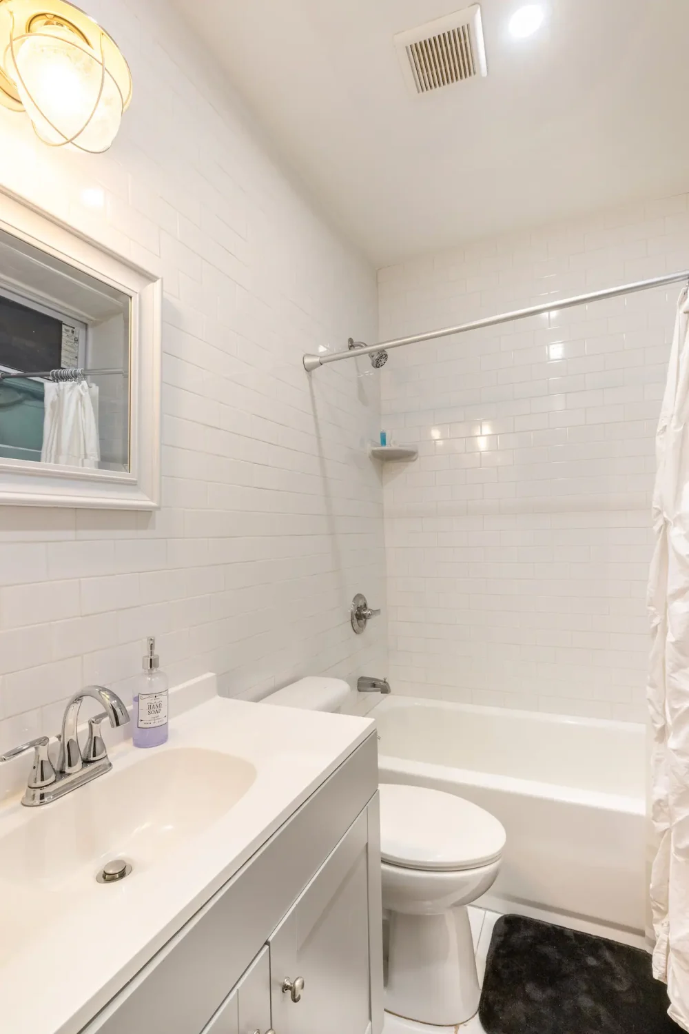 White bathroom with subway tiles.