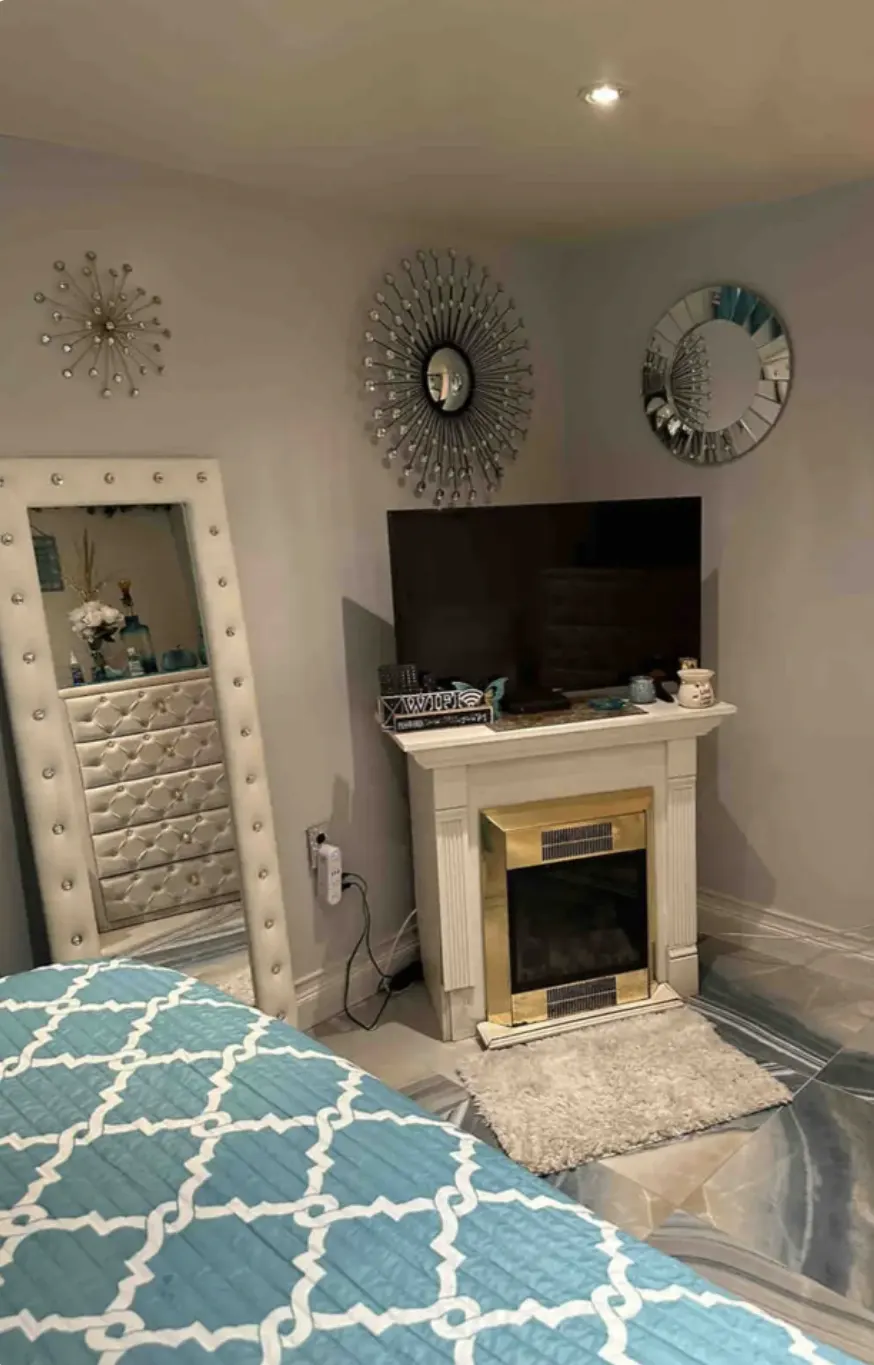 Modern cozy bedroom with fireplace.