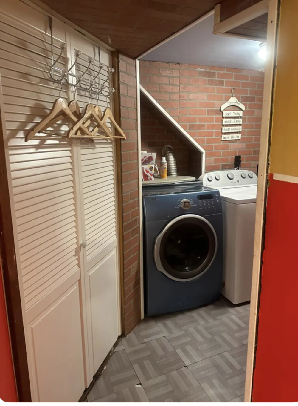 Laundry room with brick walls.