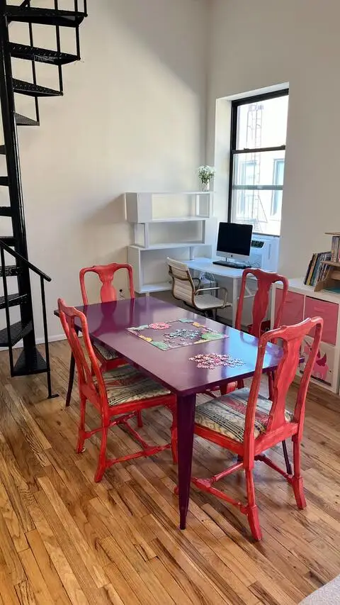 Colorful dining area with spiral staircase