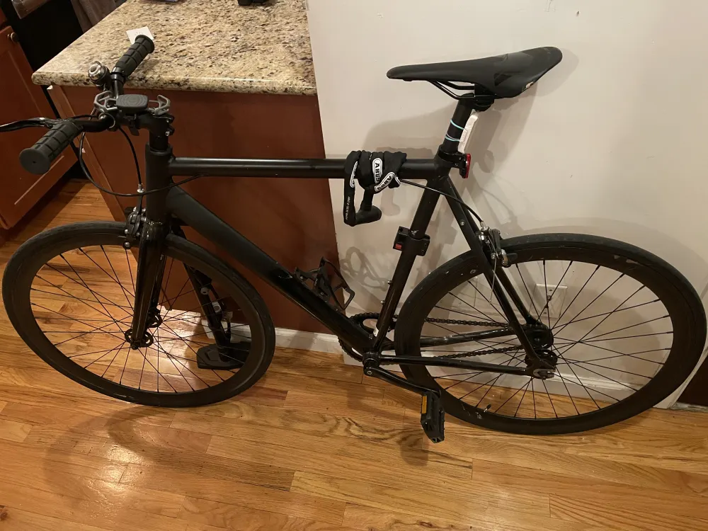 Black bicycle leaning against counter