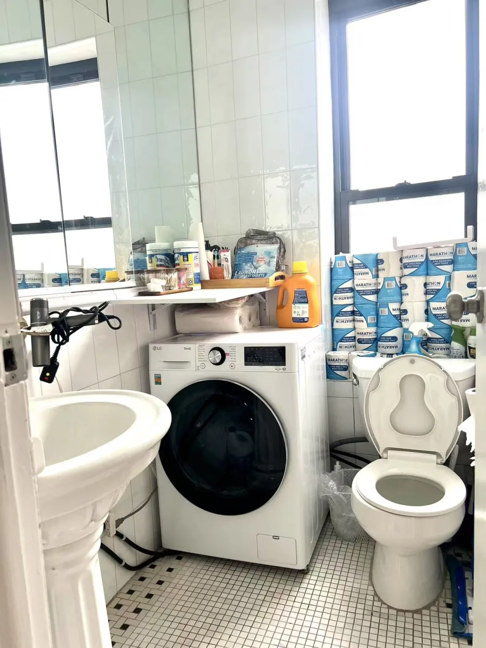 Compact bathroom with laundry facilities.