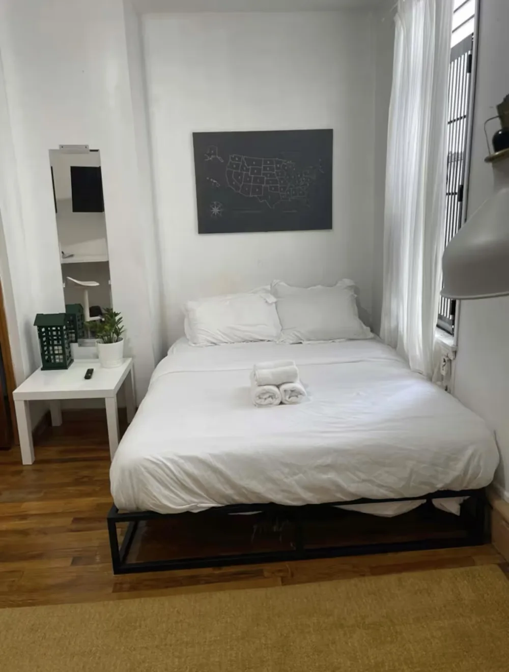 Minimalist bedroom with white bedding.