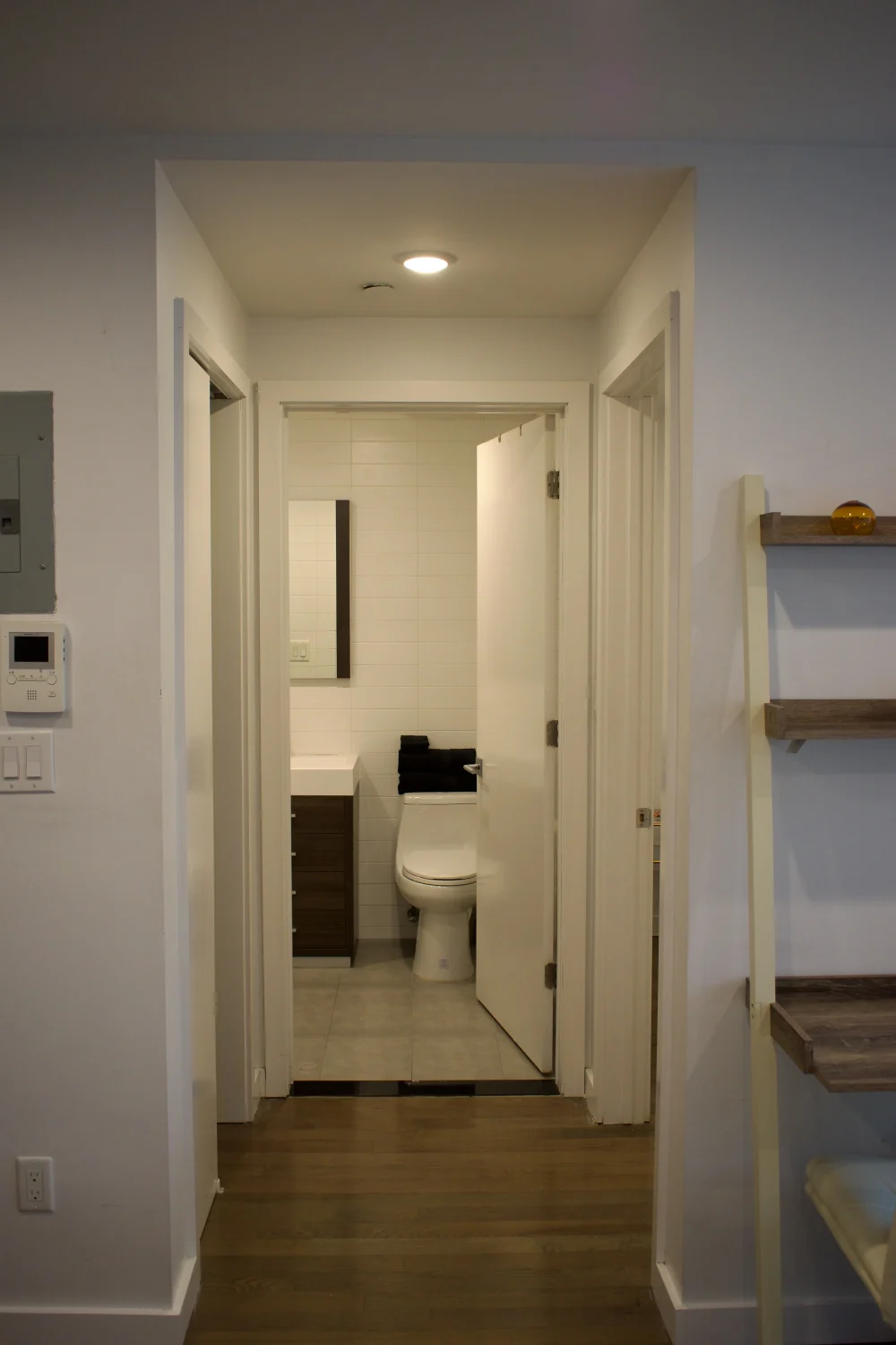 Hallway view of bathroom entrance.