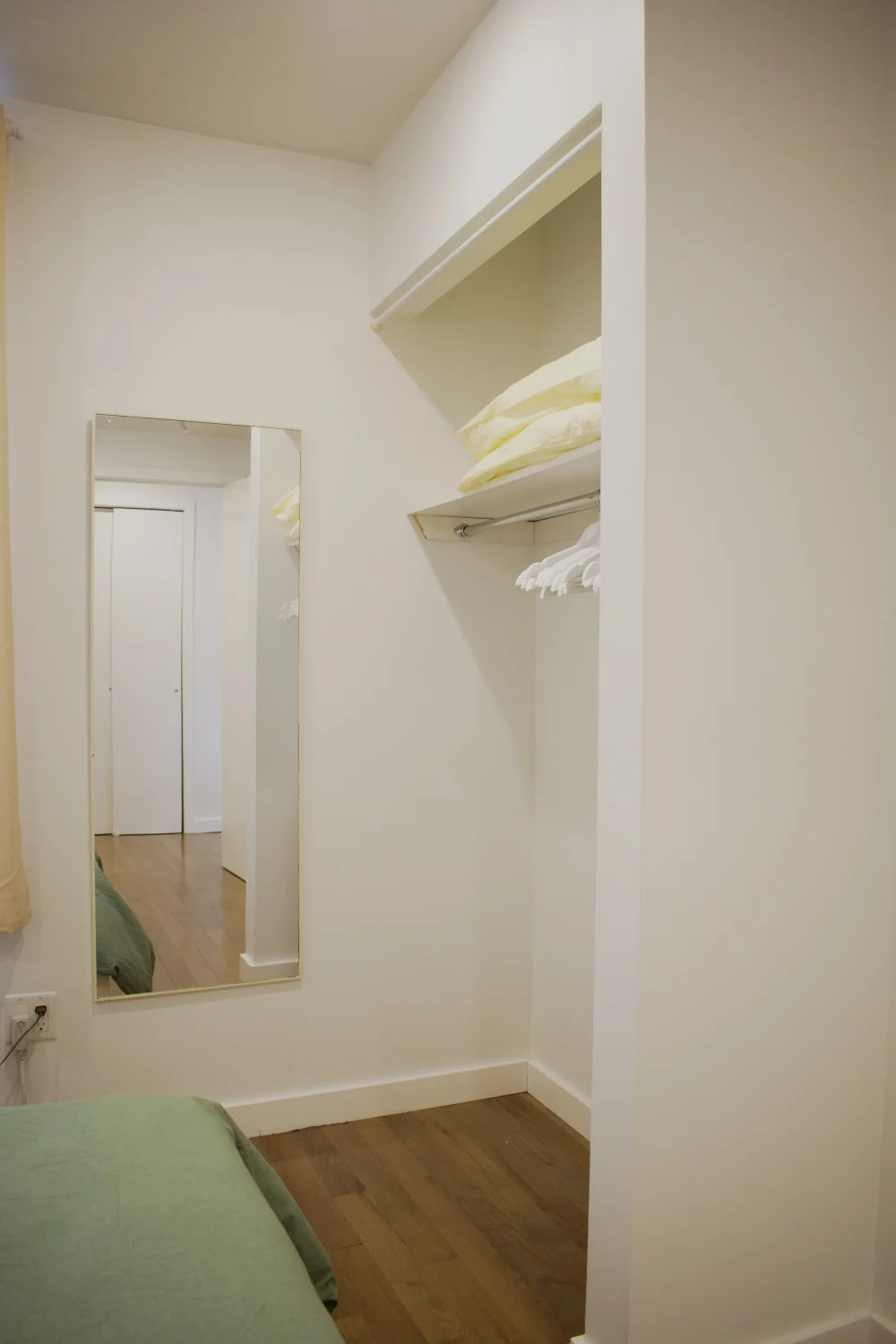 Minimalistic room with mirror, closet.