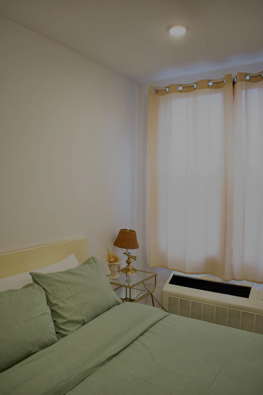 Cozy bedroom with green bedding.