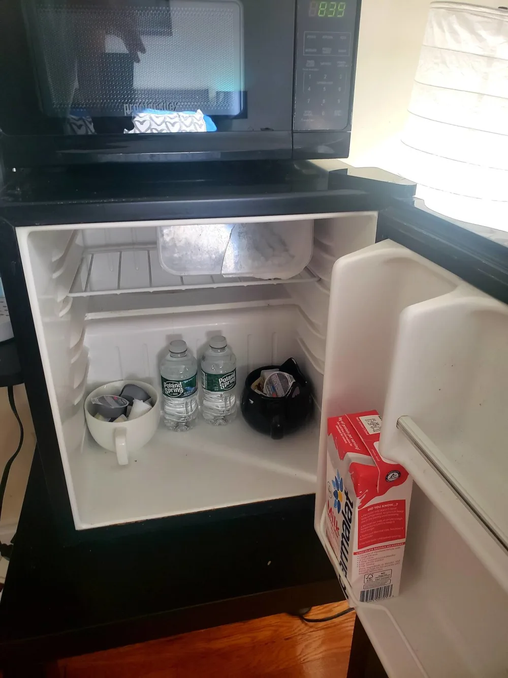 Mini-fridge with bottled water.
