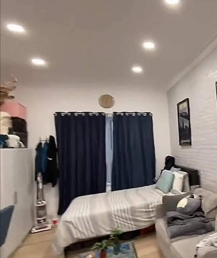 Cozy bedroom with blue curtains.