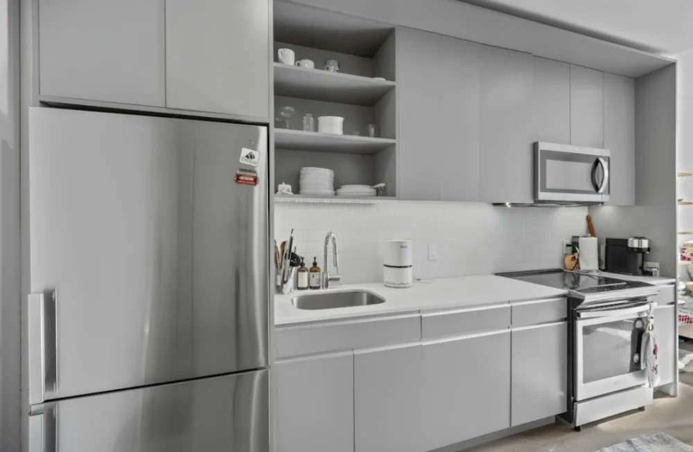 Modern kitchen with stainless appliances.