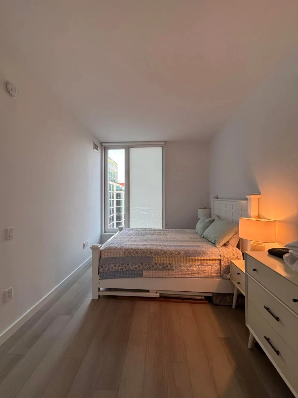 Modern bedroom with soft lighting.