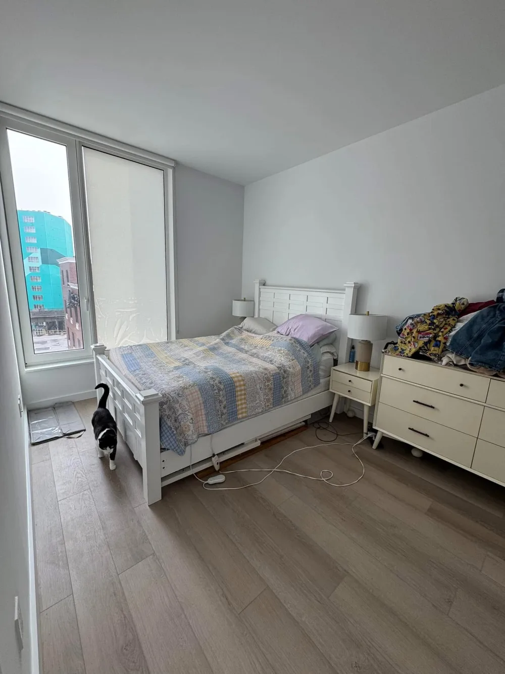 Minimalist bedroom with wooden floor.