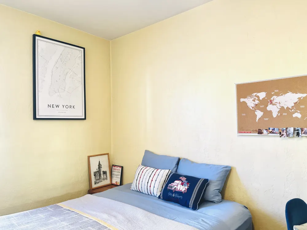 Cozy bedroom with travel-themed decor.