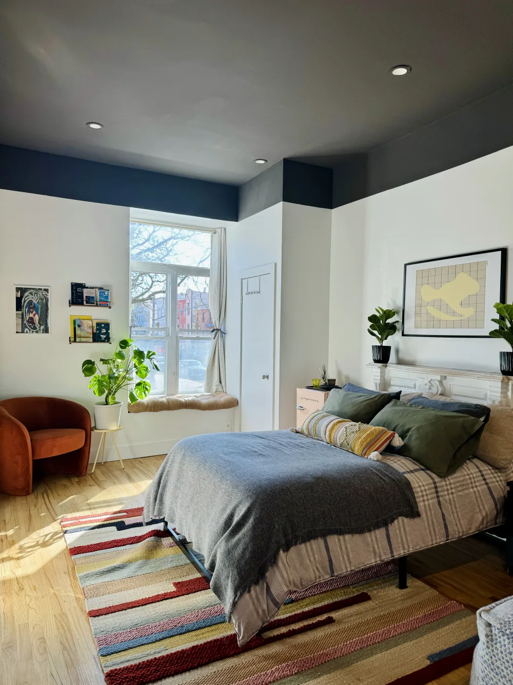 Cozy bedroom with large window.