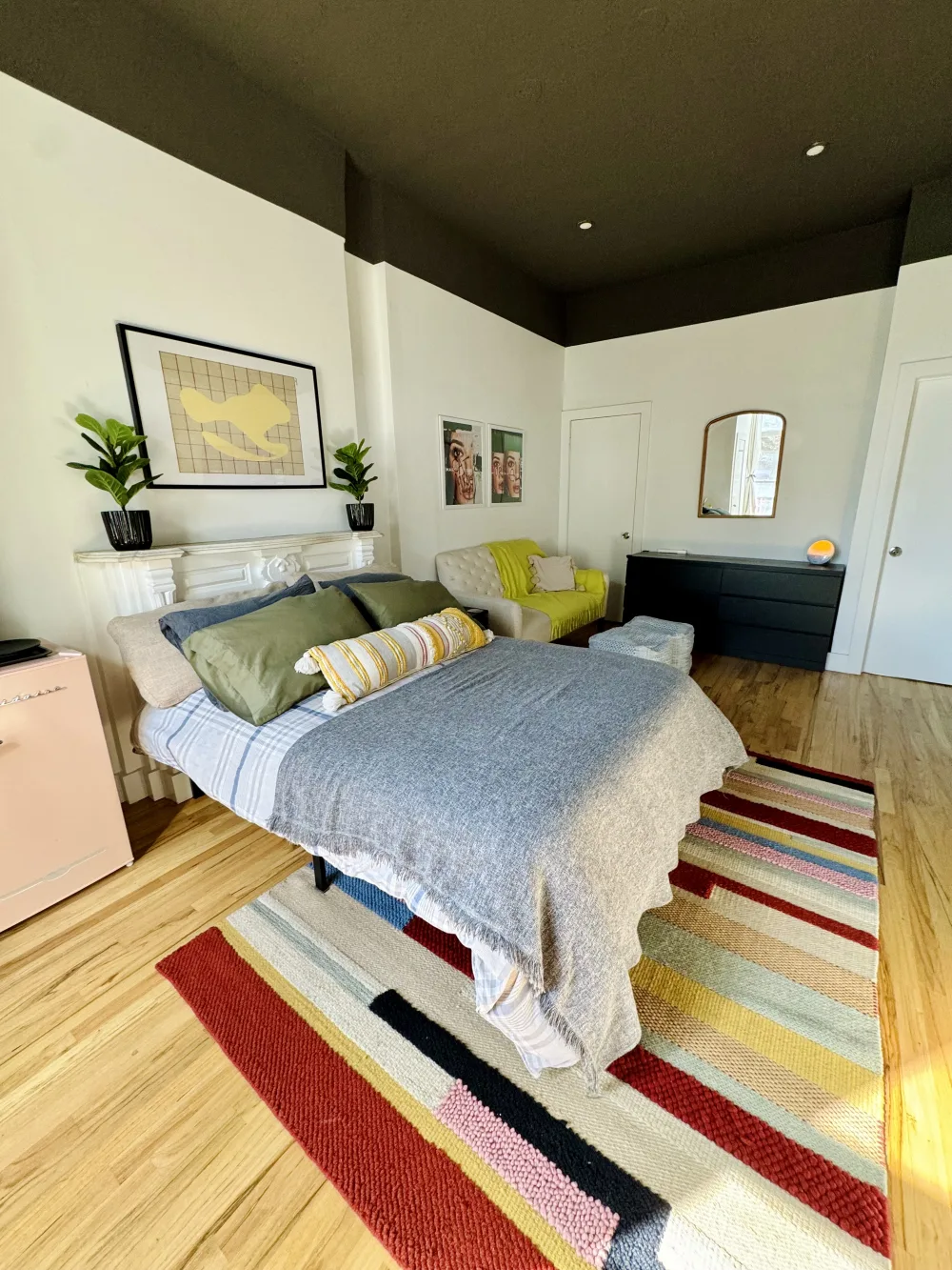 Bright, cozy bedroom with artwork.