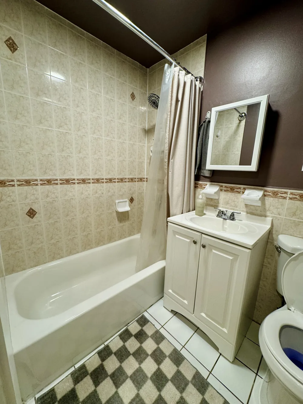 Compact bathroom with white fixtures.