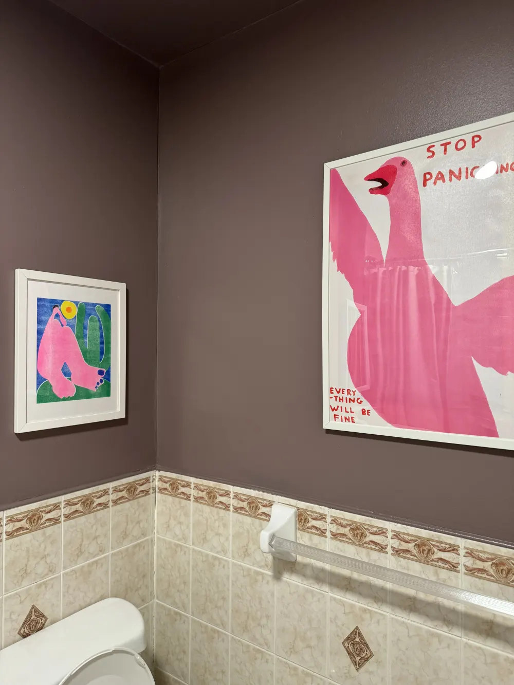 Bathroom with pink bird paintings.