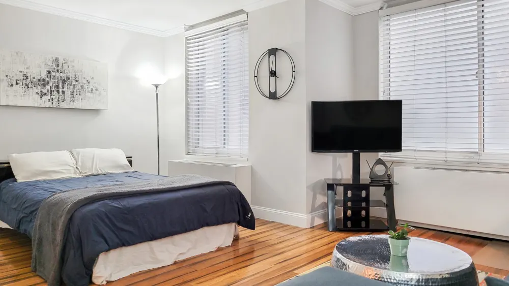 Modern bedroom with wooden flooring.