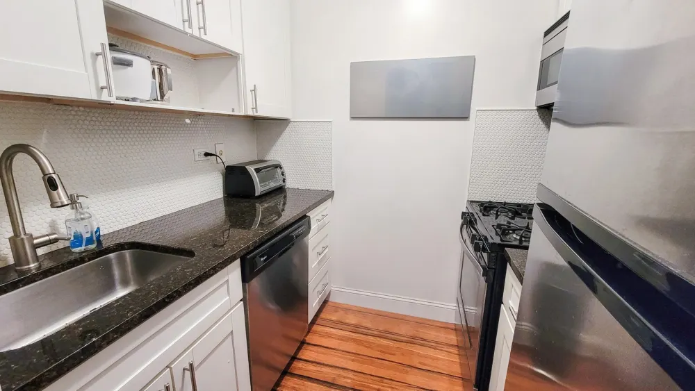 Modern kitchen with stainless steel appliances.