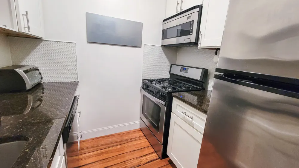 Modern kitchen with stainless steel appliances.