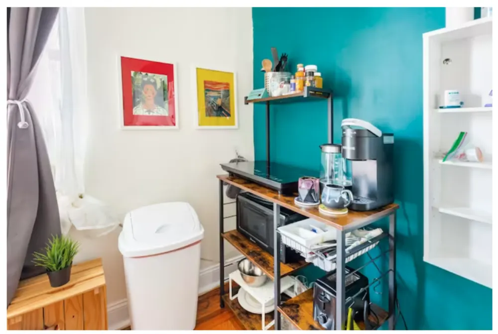 Cozy kitchenette with vibrant artwork.