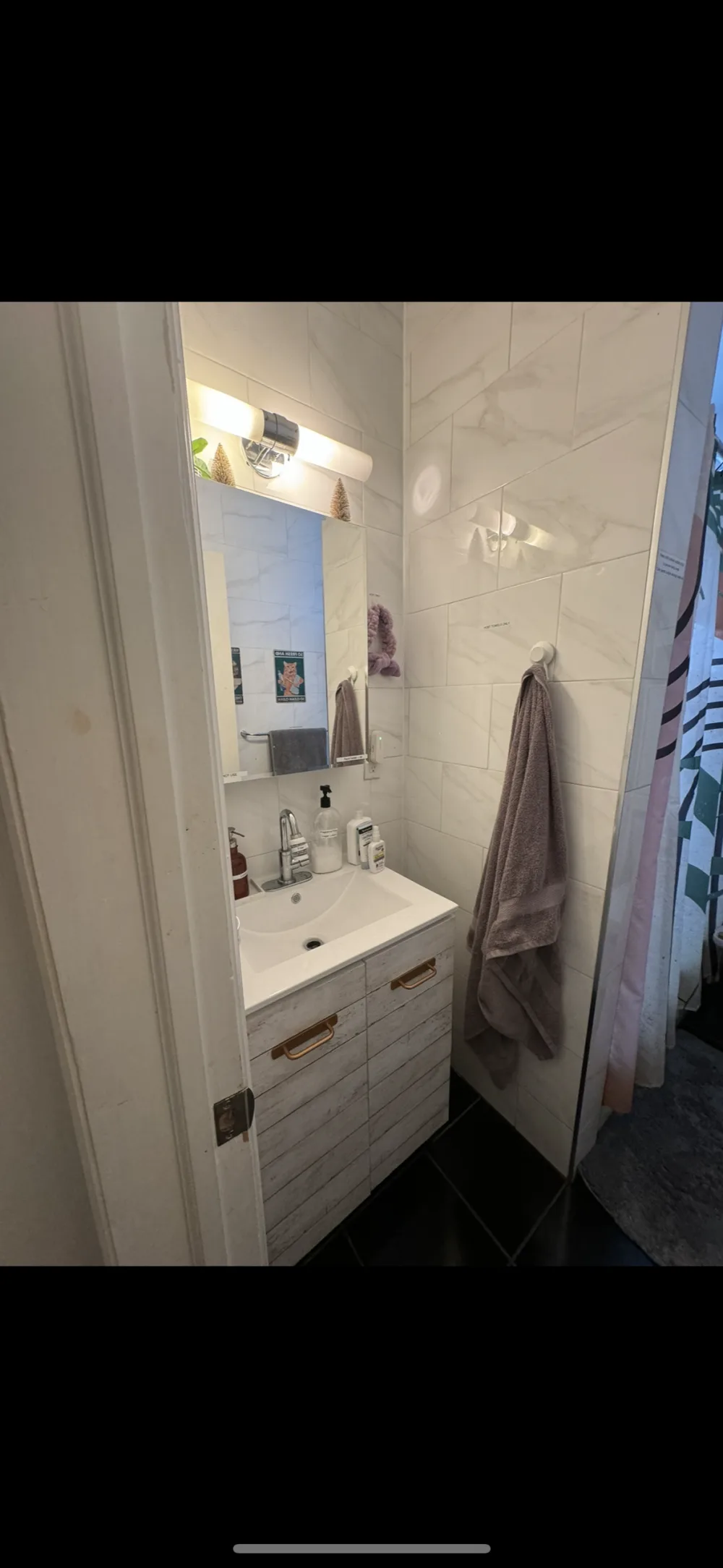 Compact, modern bathroom with vanity.