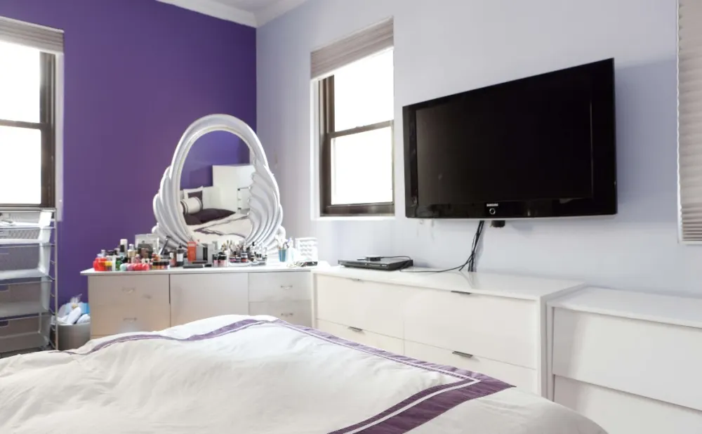 Bedroom with purple accent wall.