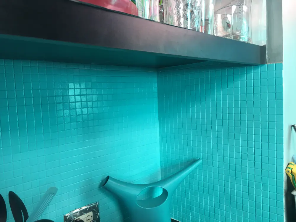 Turquoise tiled kitchen corner view.