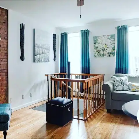 Cozy living room with staircase.