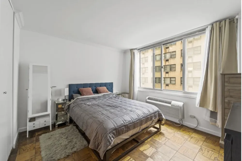 Bright room with cozy bed.