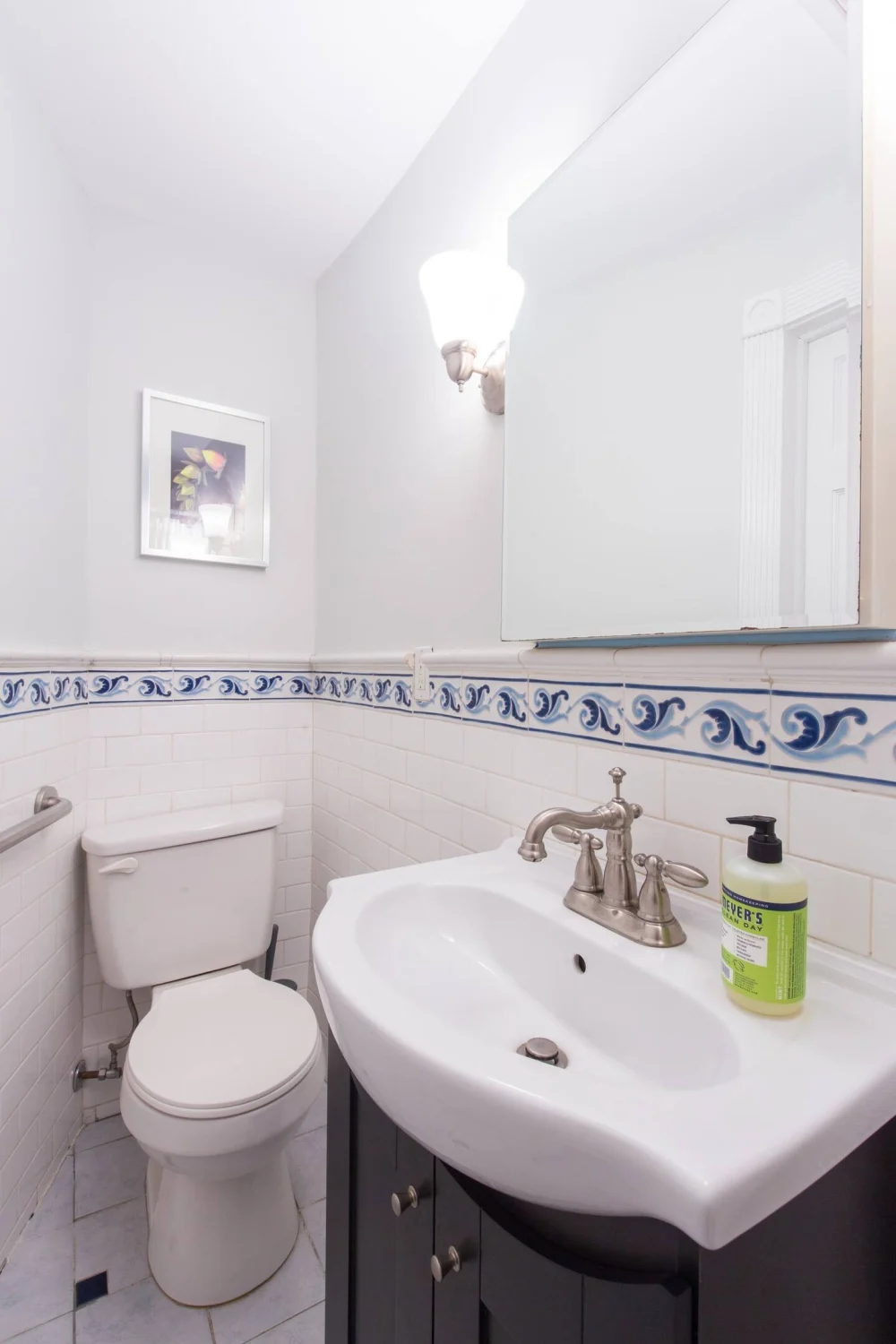 Small bathroom with tiled walls.
